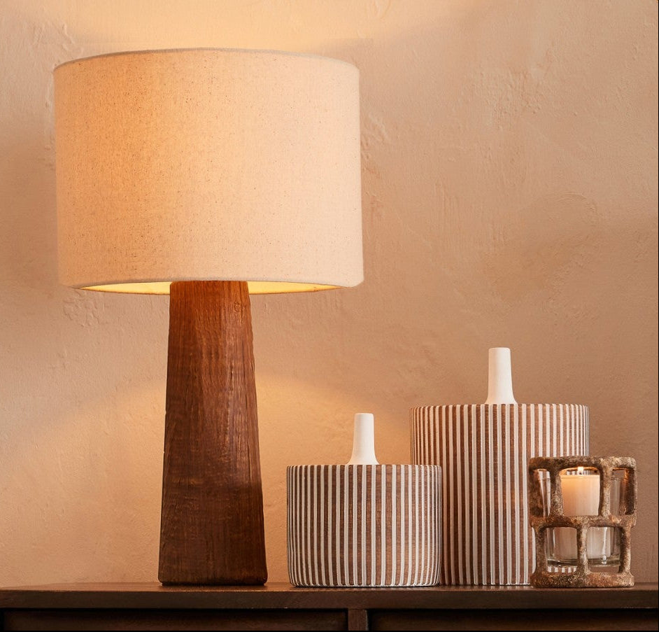 Pot décoratif en ciment avec couvercle, ambiance chaleureuse et moderne.